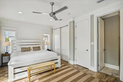 a white bedroom with a bed and a ceiling fan at Makin Memories by 30A Escapes in Rosemary Beach