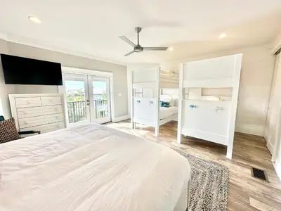 a white bedroom with a large bed and a window at Makin Memories by 30A Escapes in Rosemary Beach