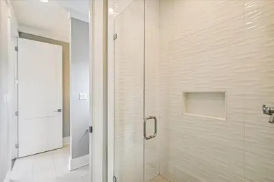 a shower with a glass door in a bathroom at Makin Memories by 30A Escapes in Rosemary Beach