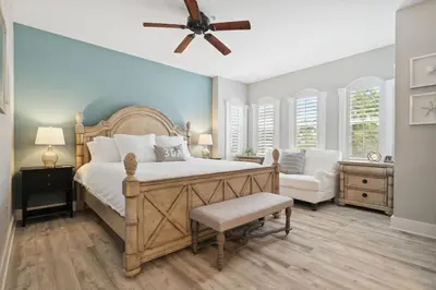 a bedroom with a large bed and a ceiling fan at Seagrove Stillhouse by 30A Escapes in Seagrove Beach