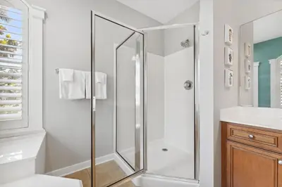a white bathroom with a shower and a sink at Seagrove Stillhouse by 30A Escapes in Seagrove Beach