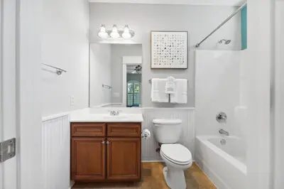a bathroom with a toilet and a sink and a tub at Seagrove Stillhouse by 30A Escapes in Seagrove Beach