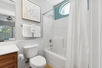 a white bathroom with a toilet and a tub and a sink at Seagrove Stillhouse by 30A Escapes in Seagrove Beach
