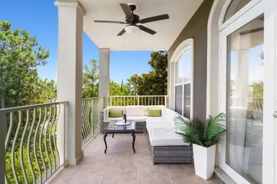 a porch with a couch and a ceiling fan at Seagrove Stillhouse by 30A Escapes in Seagrove Beach