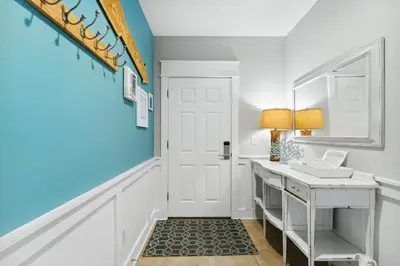 a bathroom with a white sink and blue walls at Seagrove Stillhouse by 30A Escapes in Seagrove Beach