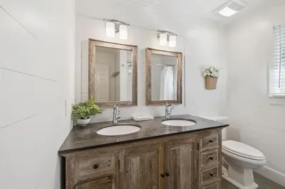 a bathroom with two sinks and a toilet at All Our Summers by 30A Escapes in Seagrove Beach