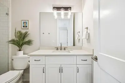 a bathroom with a sink and a toilet and a mirror at NamaStay by 30A Escapes in Seacrest
