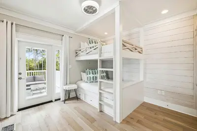 a bedroom with white bunk beds and a doorway at NamaStay by 30A Escapes in Seacrest