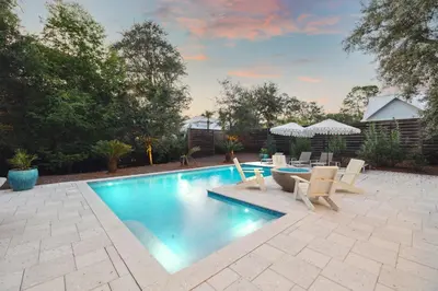 a swimming pool with a table and chairs next to it at NamaStay by 30A Escapes in Seacrest