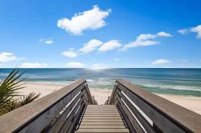 a stairway to the beach with the ocean at NamaStay by 30A Escapes in Seacrest