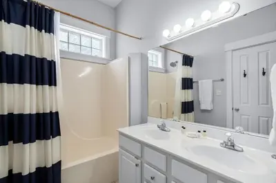 a white bathroom with a sink and a mirror at Sunnyside #7 by 30A Escapes in Seacrest