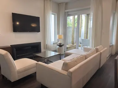 a living room with a couch and a fire place at The Pointe Unit 111 by 30A Escapes in Rosemary Beach