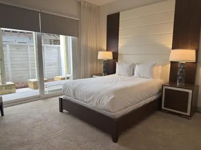 a bedroom with a large bed and a large window at The Pointe Unit 111 by 30A Escapes in Rosemary Beach