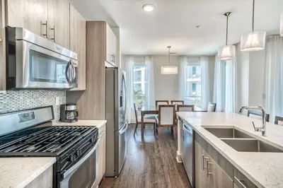 a kitchen with a stove top oven next to a counter at The Pointe Unit 121 by 30A Escapes in Rosemary Beach