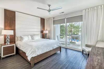 a bedroom with a bed and a large window at The Pointe Unit 121 by 30A Escapes in Rosemary Beach