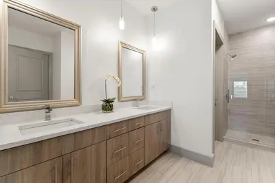 a bathroom with a sink and a mirror and a shower at The Pointe Unit 122 by 30A Escapes in Rosemary Beach