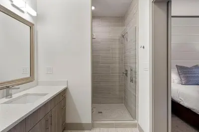 a bathroom with a walk in shower next to a sink at The Pointe Unit 122 by 30A Escapes in Rosemary Beach