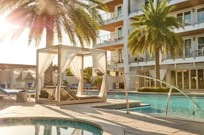 a hotel swimming pool with a gazebo and palm trees at The Pointe Unit 122 by 30A Escapes in Rosemary Beach