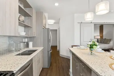 a kitchen with a sink and a refrigerator at The Pointe Unit 122 by 30A Escapes in Rosemary Beach