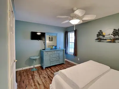 a bedroom with a bed and a dresser and a ceiling fan at Horizon South 57-105 in Panama City Beach