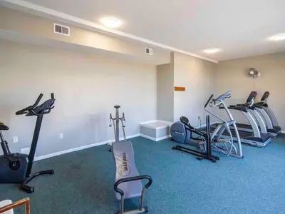 a gym with treadmills and exercise equipment in a room at Horizon South 57-105 in Panama City Beach