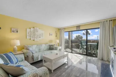 a living room with a couch and a table at Moondrifter 207 in Panama City Beach