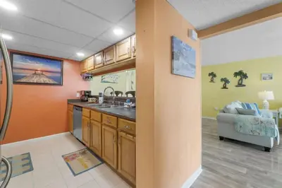 a kitchen with a sink and a couch in a room at Moondrifter 207 in Panama City Beach