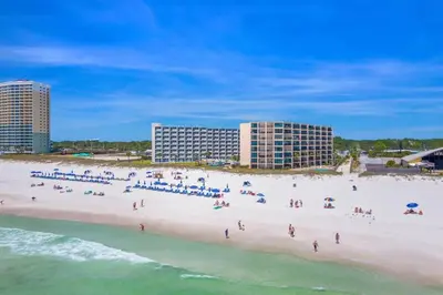 a group of people on a beach near the ocean at Moondrifter 207 in Panama City Beach