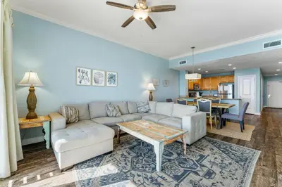 a living room with a couch and a table at Stunning Gulf Front 3BD Condo! with Beach Chair Service for 4! presented by Dolce Vita Getaways PCB! in Panama City Beach