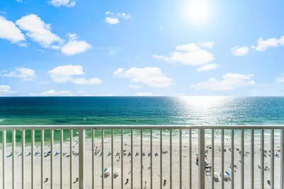 a view of a beach with chairs and the ocean at Stunning Gulf Front 3BD Condo! with Beach Chair Service for 4! presented by Dolce Vita Getaways PCB! in Panama City Beach