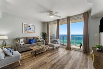 a living room with a couch and a view of the ocean at Shores of Panama by Blue Swell in Panama City Beach