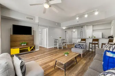 a living room with a couch and a tv at Shores of Panama by Blue Swell in Panama City Beach