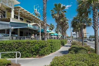 a street in front of a building with palm trees at Shores of Panama by Blue Swell in Panama City Beach