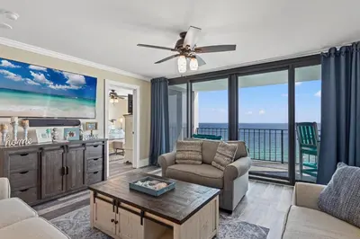 a living room with a view of the ocean at Watercrest 1704 - Serenity Shores in Panama City Beach