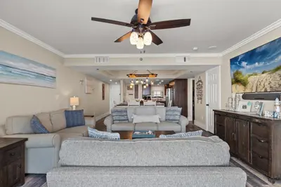 a living room with a couch and a ceiling fan at Watercrest 1704 - Serenity Shores in Panama City Beach