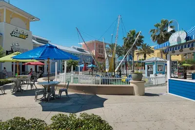 a patio with tables and umbrellas on a street at Shores of Panama 1408 - Seaside Getaway in Panama City Beach