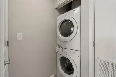 two washer and dryer machines in a room at Shores of Panama 1410 - Seaside Retreat in Panama City Beach