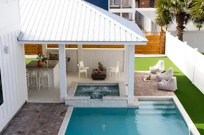 a swimming pool in a backyard with a gazebo at The Taj Of The Gulf! Luxury Beach Mansion! Sleeps 37, private pool & hot tub, putting golf in Panama City Beach