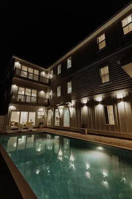 a large swimming pool in front of a building at night at The Taj Of The Gulf! Luxury Beach Mansion! Sleeps 37, private pool & hot tub, putting golf in Panama City Beach