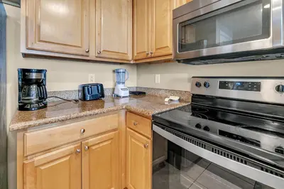 a kitchen with a stove and a microwave at Marisol 204 by Emerald Coast Retreats in Panama City Beach