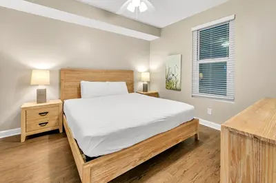 a bedroom with a large bed and a window at Marisol 204 by Emerald Coast Retreats in Panama City Beach