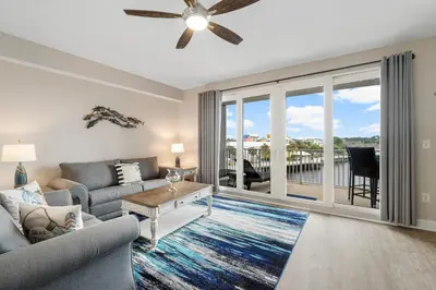 a living room with a couch and a ceiling fan at Lakeview Luxury at Laketown Wharf #235 by Nautical Properties in Panama City Beach