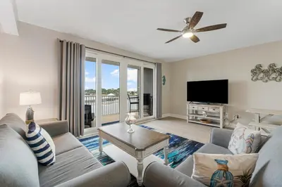 a living room with a couch and a flat screen tv at Lakeview Luxury at Laketown Wharf #235 by Nautical Properties in Panama City Beach