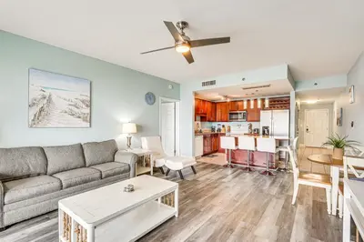 a living room with a couch and a table at Panama City Beach Condo - Walk to the Ocean! in Panama City Beach