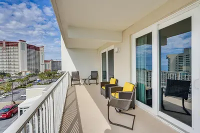 a balcony with chairs and a view of a city at Panama City Beach Condo - Walk to the Ocean! in Panama City Beach