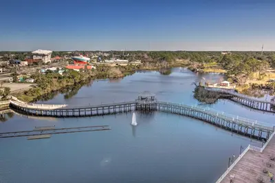 an aerial view of a river with a dock at Panama City Beach Condo - Walk to the Ocean! in Panama City Beach