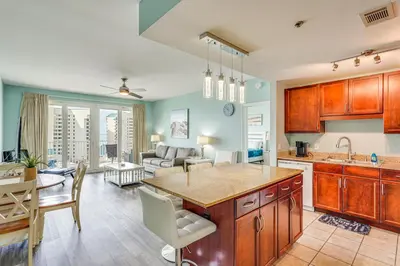 a kitchen and living room with a couch and a table at Panama City Beach Condo - Walk to the Ocean! in Panama City Beach