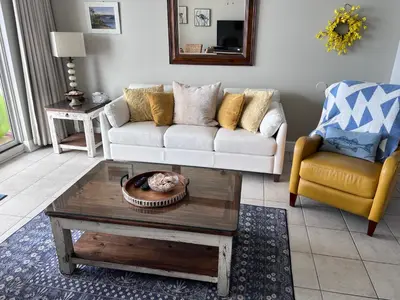 a living room with a couch and a coffee table at Majestic Beach Towers 905 in Panama City Beach