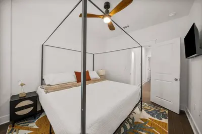 a bedroom with a canopy bed with a ceiling fan at Special ! Free Golf Cart ! Spring Paradise! in Panama City Beach