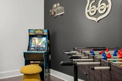 a game room with a pinball machine and dominoes at Special ! Free Golf Cart ! Spring Paradise! in Panama City Beach
